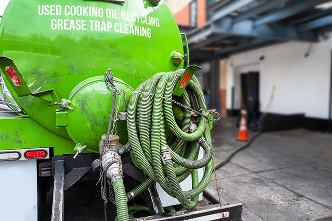 grease trap pumping truck servicing a restaurant in Belmont, MA